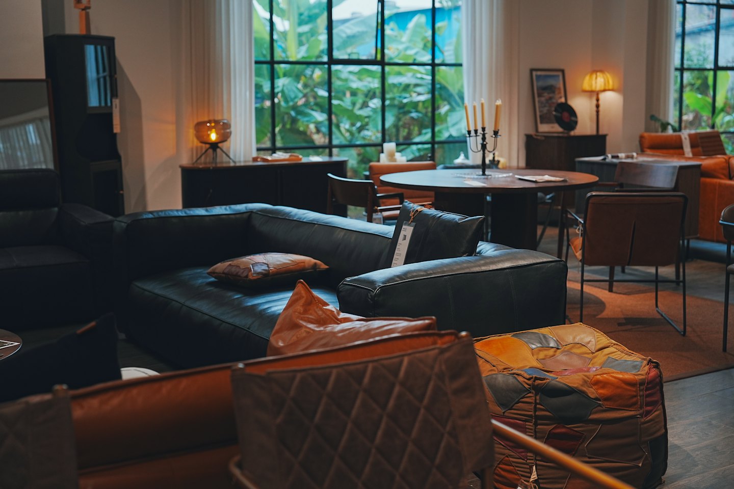 Furniture showroom with leather sofas and fabric chairs.